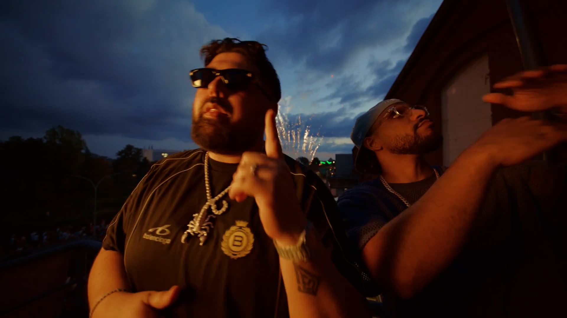 Two rappers at blue hour with fireworks behind them during the Killy Manjaro Euromix video shoot