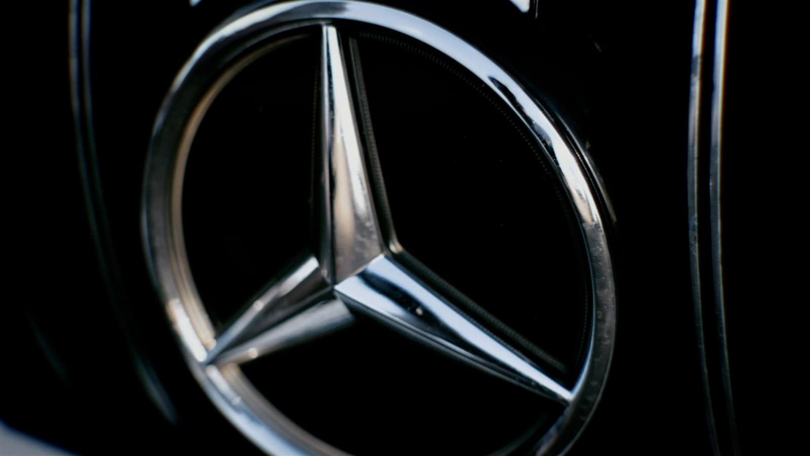 Close-up of a chrome Mercedes star, a still from a music video production