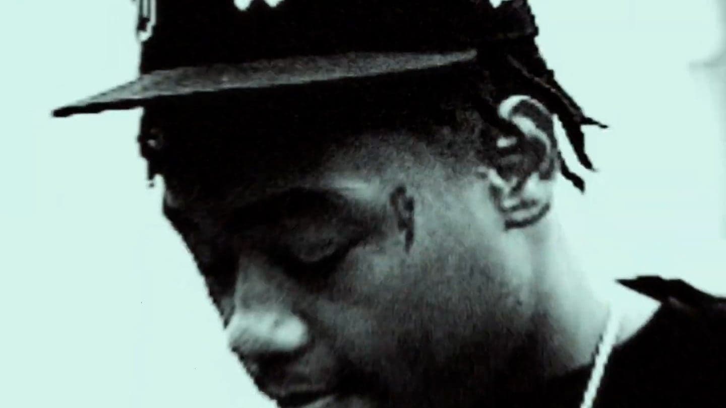 Black-and-white portrait still from a music video production
