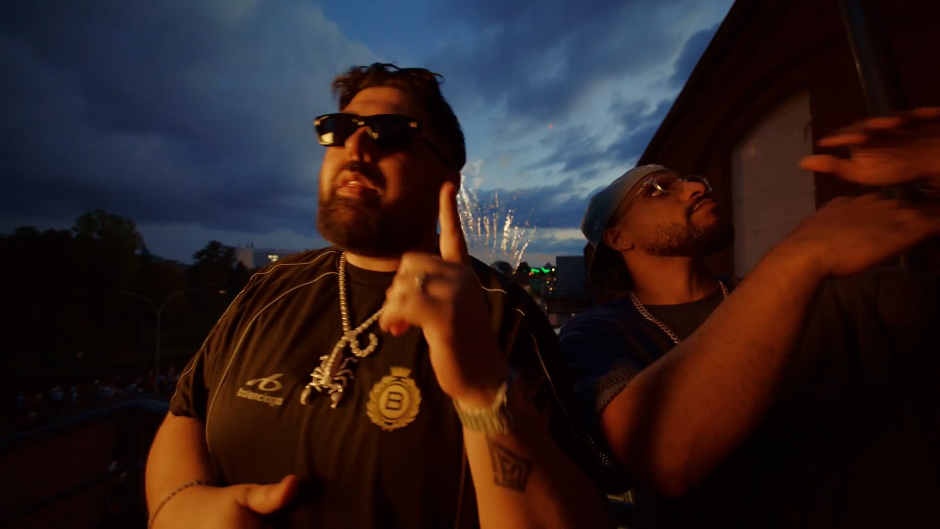 Two rappers at blue hour with fireworks behind them during the Killy Manjaro Euromix video shoot